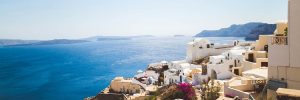 Picturesque clifftop houses and flowers in Santorini cruise port