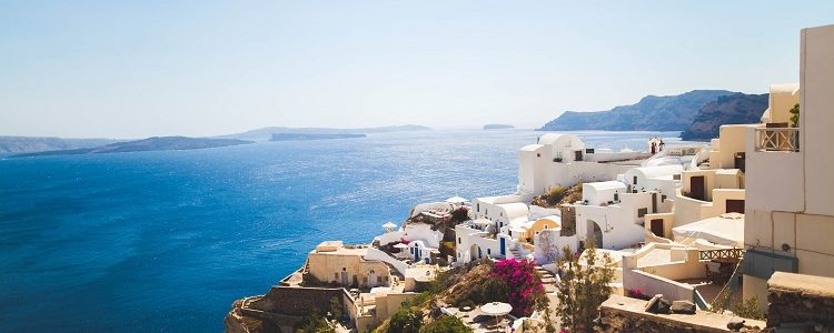 Picturesque clifftop houses and flowers in Santorini cruise port