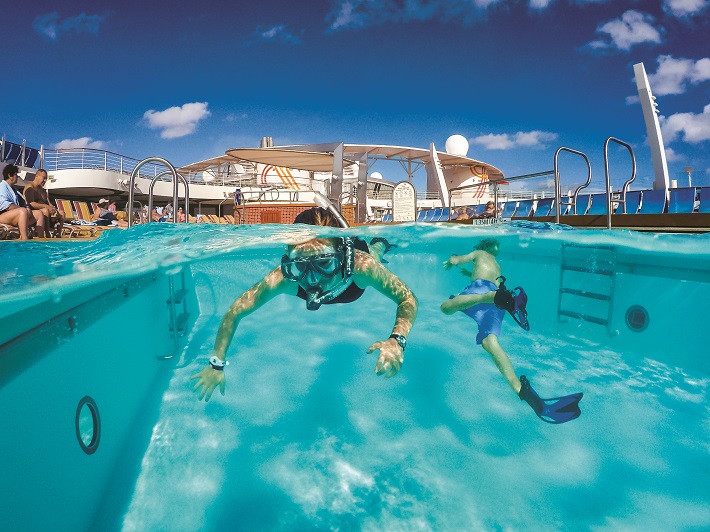 Underwater shot of children snorkelling in the pool on a Royal Caribbean cruise ship