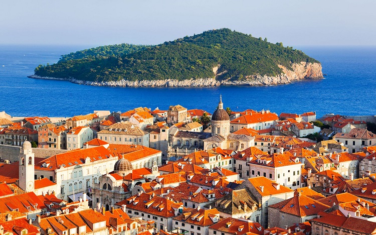 View out to a Croatian island from the orange rooftops of Dubrovnik