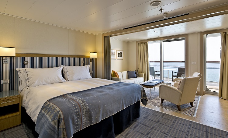 The bedroom area in a Penthouse Junior Suite on-board a Viking Ocean cruise ship