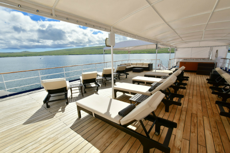Plush loungers on the sun deck on-board Celebrity Xperience