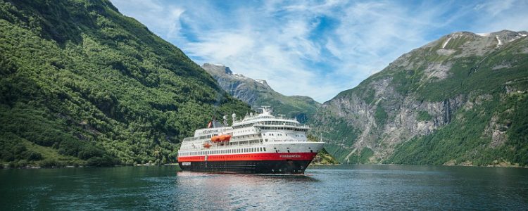 Hurtigruten's MS Finnmarken cruise ship sailing through Geirangerfjord