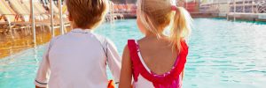 Kids sat poolside on-board Royal Caribbean