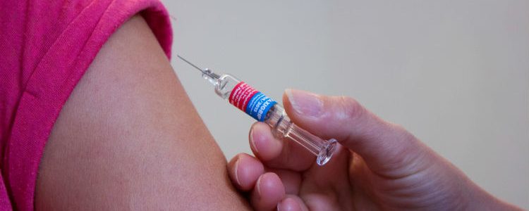 Person getting a vaccination at the doctors