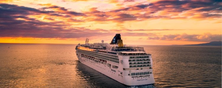 Large cruise ship sailing at sunset